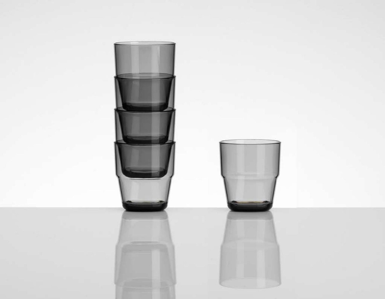 Stacked smoke-coloured drinking tumblers